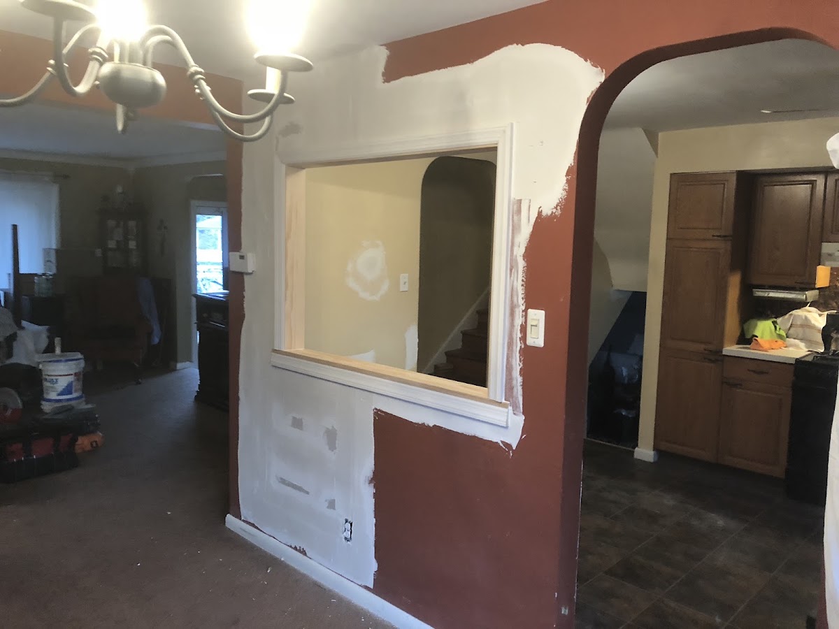 In-progress wall opening and drywall repair work